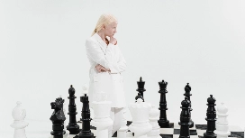 Professional evaluating chess moves to develop critical thinking skills and improve strategic decision-making