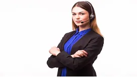 A confident customer service professional wearing a headset stands with folded arms, representing advanced leadership and service excellence training.