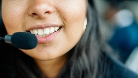 Close-up of smiling call centre agent with headset – study customer services skills online with OHSC