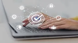 Hands typing on a laptop with digital security icons overlayed, representing essential skills and concepts taught in Level 3 cyber security certificate courses.