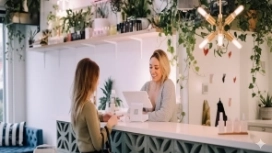 Professionals exchanging information at a service counter, illustrating data-driven decision making in the workplace
