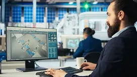 An engineer working on a computer displaying workflow diagrams, representing automation and data pipeline design with Apache Airflow.