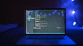 Python developer cleaning and transforming datasets on a laptop, representing OHSC’s free Data Wrangling with Python course.