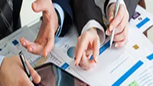 Business professionals reviewing charts and digital reports, illustrating key concepts in online sales, analytics, and e-commerce management skills.