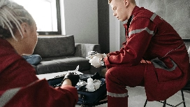 Emergency responders preparing first-aid kit indoors – learn emergency preparedness in risk management short course