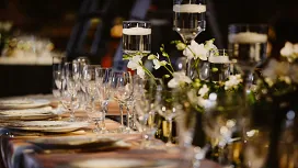 Elegant event table setup with glassware, candles and floral décor, representing skills taught in the Level 2 Certificate in Event Management.