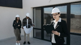 Facilities managers reviewing building plans and operations data – study facilities management online with OHSC.