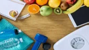 Healthy fruits, water bottles, a scale, and a fitness towel arranged on a table, symbolising basic food hygiene awareness taught in Level 1 courses.