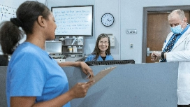 Nurses and care managers in a healthcare setting learning safety protocols – Level 4 Health & Social Care online