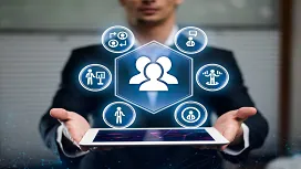 Business professional holding a digital tablet displaying HR icons representing recruitment, training, and employee management for HR Level 3 studies.