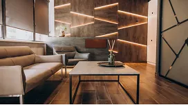 Modern minimalist interior with geometric wall lighting and contemporary furniture, representing Level 3 Certificate in Interior Design.