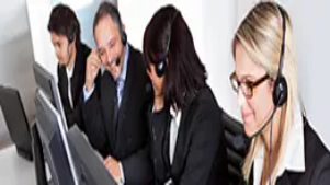 A team of professionals wearing headsets work on computers, representing online communication, digital outreach, and skills used in internet marketing training.