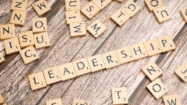 Leadership concept displayed with letter tiles, representing leadership communication skills training and influence