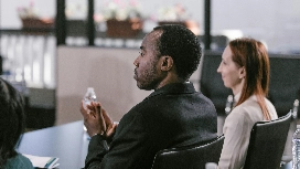 Focused professionals in a training session, demonstrating leadership qualities and active listening for OHSC.