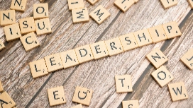 Emerging team leader guiding colleagues during a meeting, demonstrating skills to be a leader and effective leadership qualities