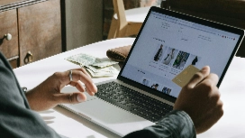 Learner managing an online store dashboard on a laptop, representing skills taught in an ecommerce management course Level 4.