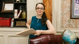 Legal professional holding documents in a law office, representing level 4 diploma in law and legal studies certificate programs