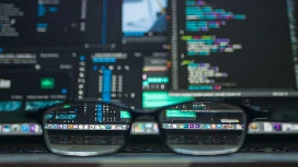 Web developer reviewing code on screen, representing level 5 diploma in IT web design and website development certificate