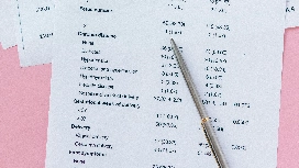 Data analyst reviewing numerical reports and datasets, representing level 7 diploma in data science and online data analysis courses
