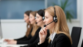Customer service professionals communicating through headsets, illustrating effective workplace communication and difficult conversations