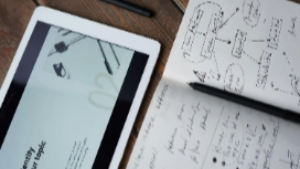 Tablet and marketing notes on a desk, showing planning and strategy skills for online Marketing short course