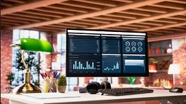 A computer monitor displaying analytics dashboards in a modern workspace, representing data visualization using Matplotlib and Seaborn.