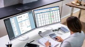 Medical billing professional working on a laptop with healthcare forms, representing OHSC’s free Medical Billing & Coding course.