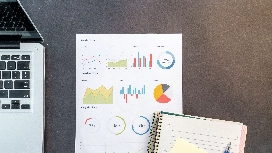 Excel charts and data reports on a desk illustrating free online Excel training for beginners and data analysis skills