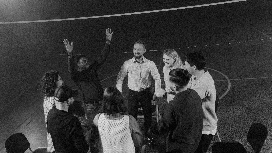 Group of people participating in an energetic coaching activity, symbolizing confidence building, communication and personality development training.