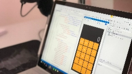 Professional working with formulas and calculations on a computer, demonstrating Excel functions and automation skills