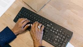 Professional typing on a keyboard, demonstrating touch typing skills and office productivity for workplace success