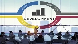 A project manager presenting a development cycle diagram to a team in a meeting room, illustrating stages of the project life cycle.