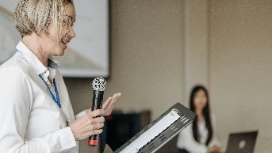 Professional delivering a confident presentation to an audience, demonstrating public presentation skills and public speaking in class