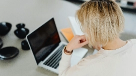 Remote professional working on laptop at home – learn remote facility management skills with OHSC free course