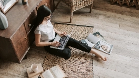 Remote life coaching student working on laptop at home, enjoying flexible online learning with OHSC free course