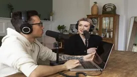 Two people recording a podcast with microphones and headphones, representing communication and media skills learned in remote PR courses.