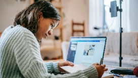 Freelance writer working on laptop at home – remote writing work free course for online careers with OHSC