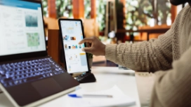 Person using a laptop and smartphone, illustrating self awareness, self management and practical everyday life skills