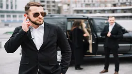 Licensed security guard monitoring entrance and checking IDs at a venue – study SIA door supervisor training and security management online