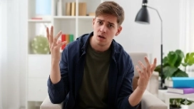 Student gesturing while learning AI image generation, representing OHSC’s Stable Diffusion free course for creative visual AI skills.