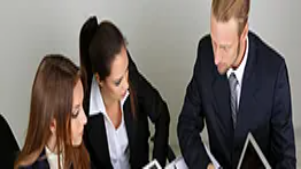 Business professionals reviewing digital documents and planning strategies, representing online business setup and entrepreneurship skills.