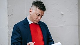 Business professional reviewing notes outdoors, representing planning, strategy and key skills taught in starting an online business courses.