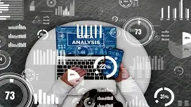 Person analyzing data on a laptop surrounded by digital charts and statistical graphics, representing statistics and probability concepts used in artificial intelligence.
