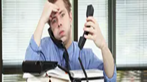Stressed office worker overwhelmed with calls and paperwork, illustrating workplace pressure addressed in stress management training.