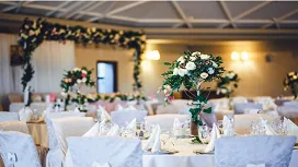 Elegant wedding reception setup with floral centerpieces and decorated tables, representing event styling and planning skills for wedding planners.