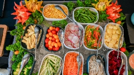 Colorful assortment of fresh vegetables and salad ingredients, representing balanced eating and healthy food choices in weight control management.