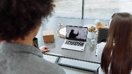 Remote workers attending an online meeting from a home office, building productivity and discipline for remote careers