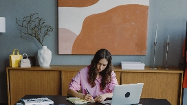 Professional working remotely from home office using a laptop, demonstrating work from home skills for beginners
