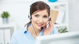 Customer service professional using a headset, illustrating workplace communication signals and effective communication skills