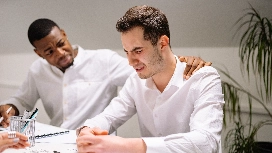 Coworker offering emotional support to a distressed colleague, highlighting workplace mental health and wellbeing